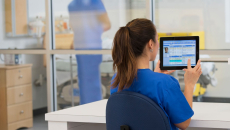Clinician works with tablet computer