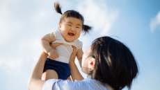 Person holding child in the air