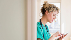 A nurse using a digital tablet