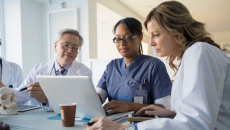 Doctors review information on a laptop