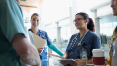 Clinical staff having a conversation in a hallway