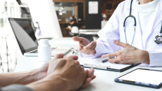 A doctor and patient in an in-person consultation