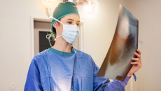 A doctor examining a patient's x-ray image