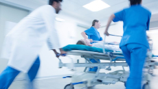 An emergency team pushing a patient on a gurney