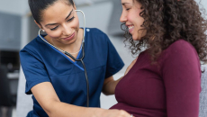 A doctor checking up on a pregnant person
