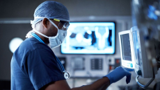 A surgeon checking a monitor in the operating room