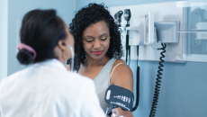 A person getting their blood pressure checked at the doctor's office.