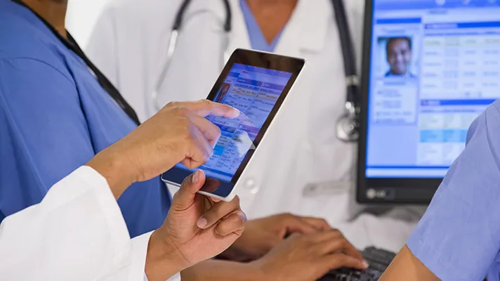 EHR on tablet with doctor scrolling