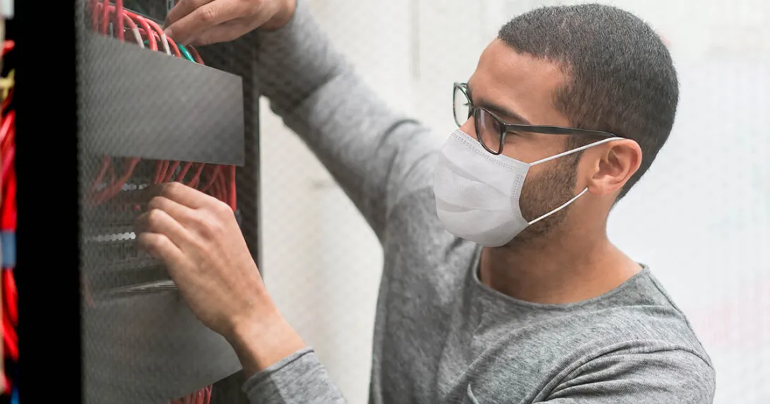 Photograph of a man working on a server