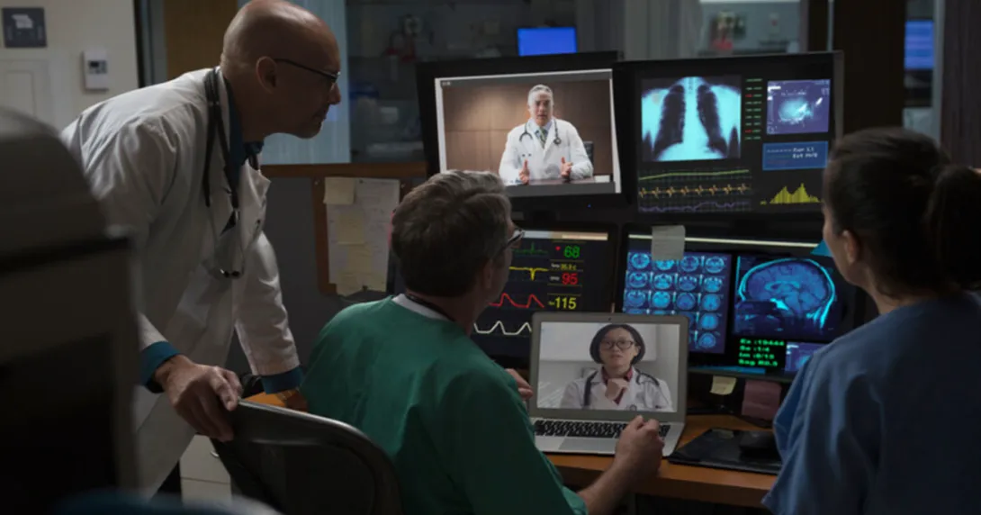 Medical professionals examine screens