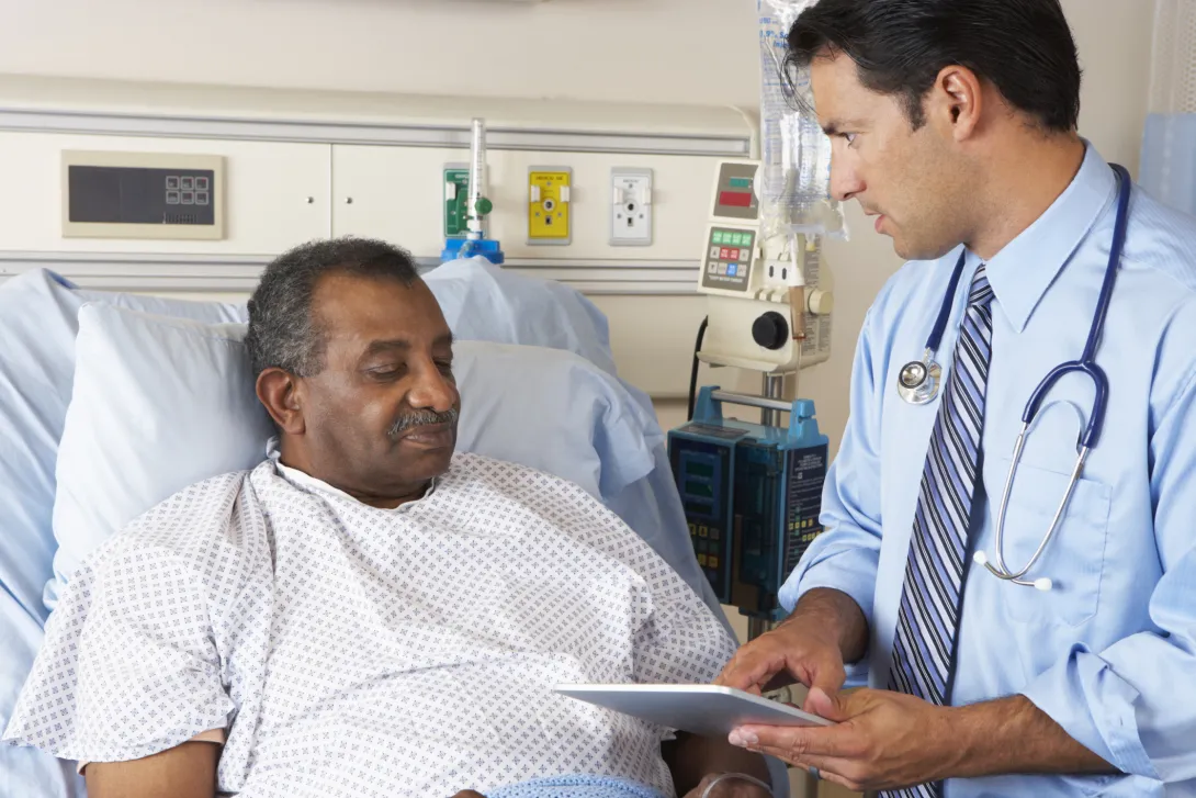 doctor using tablet with hospital patient