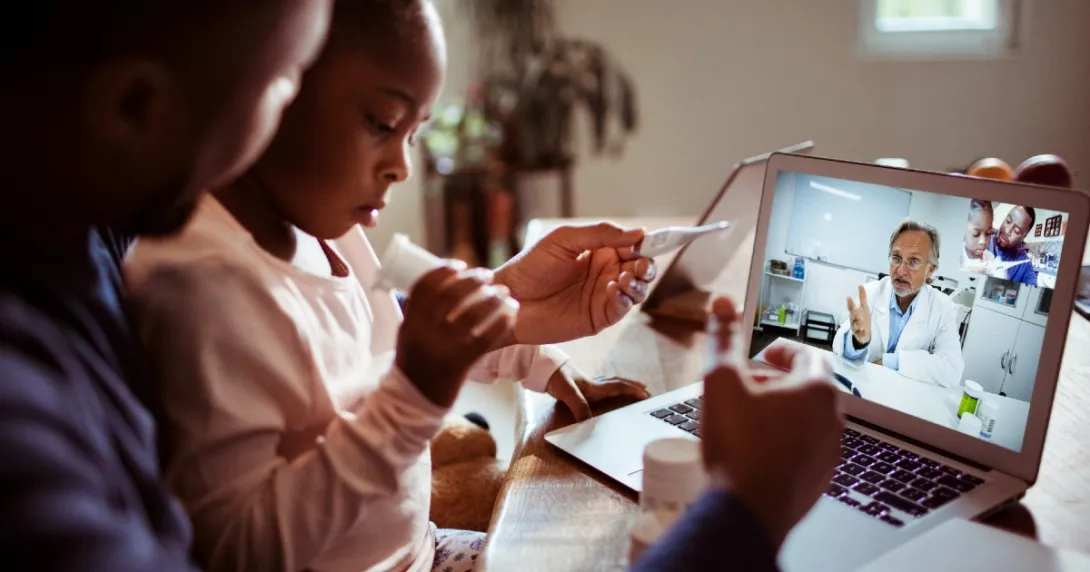 Parent and child talk with doctor via telehealth