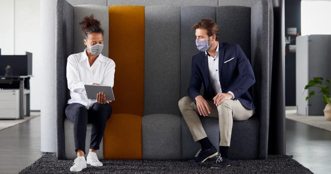 People examine tablet in office meeting