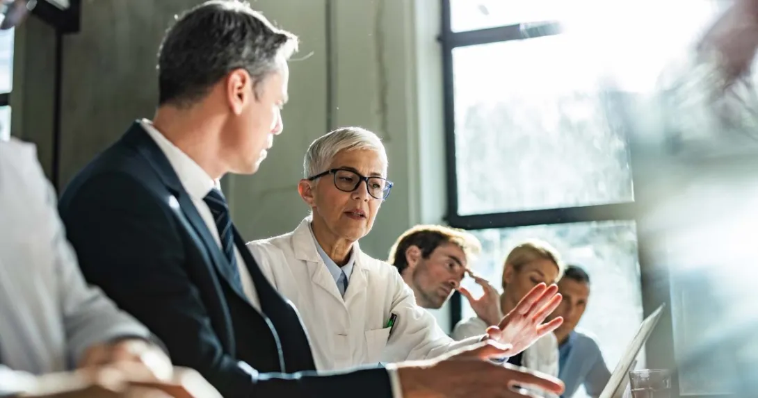healthcare executives at a table, leaders, health IT