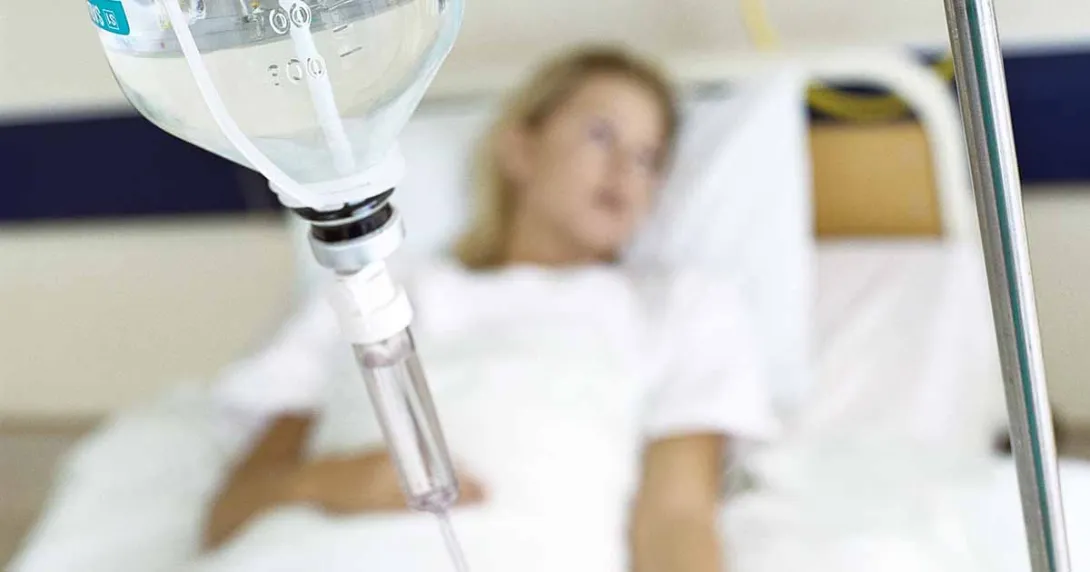 Patient lying in hospital bed with IV drip