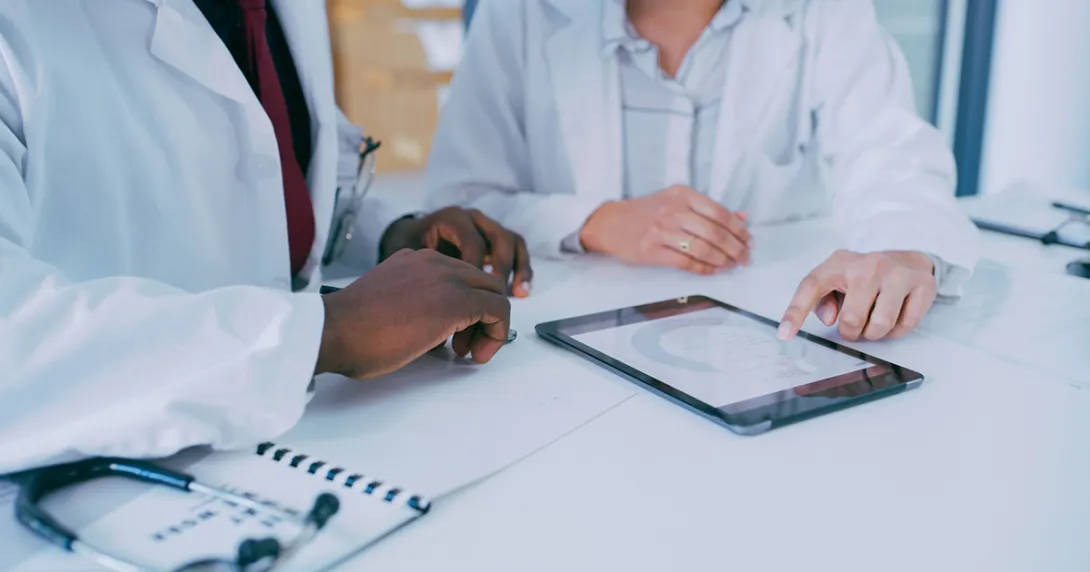 Healthcare workers looking at a tablet