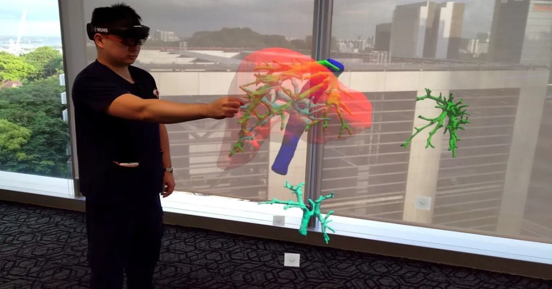 A doctor wearing an MR headset sees and controls a projected 3D hologram of a patient’s liver scan.
