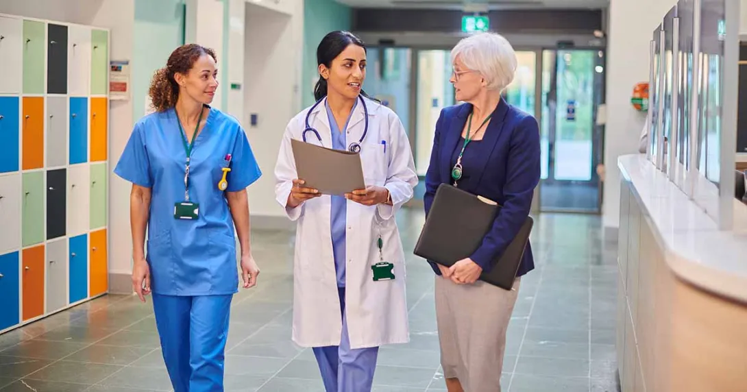 Healthcare workers talking in hallway