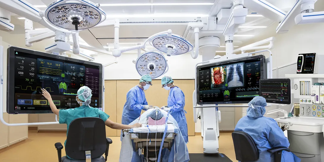 Surgery taking place with doctors working from digital monitors