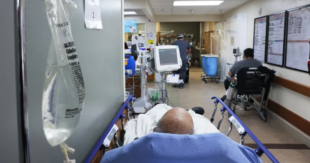Bald male patient lays in an ER hallway