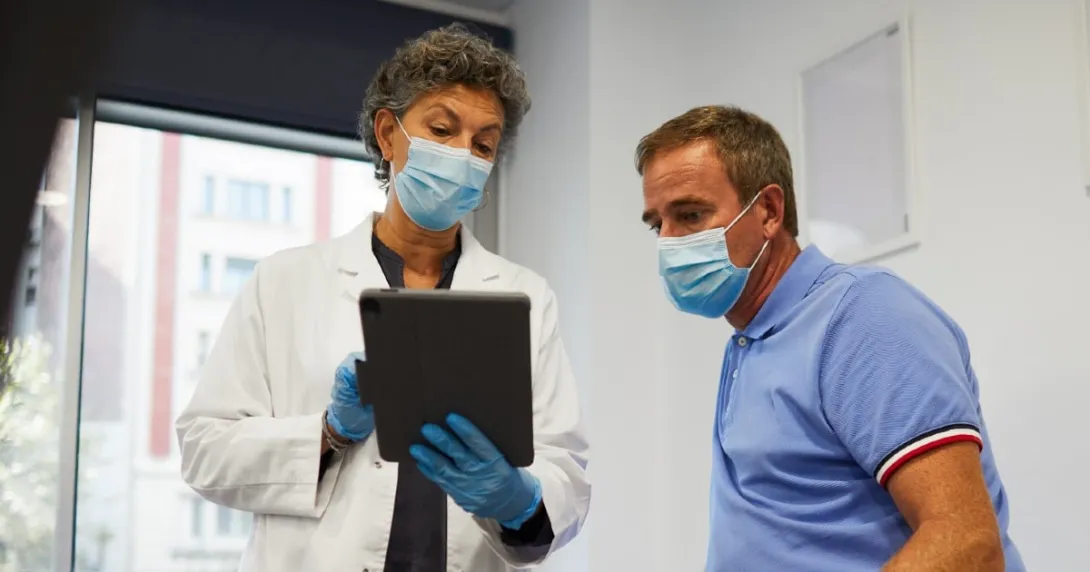 A medical professional using an EHR with a patient