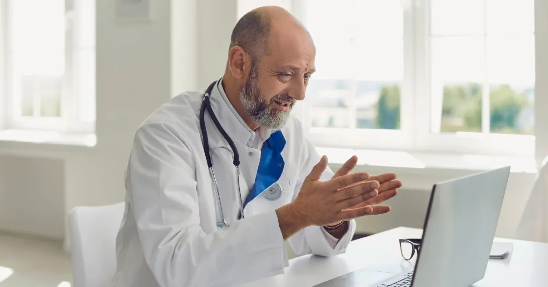 A doctor speaks with a patient via videochat
