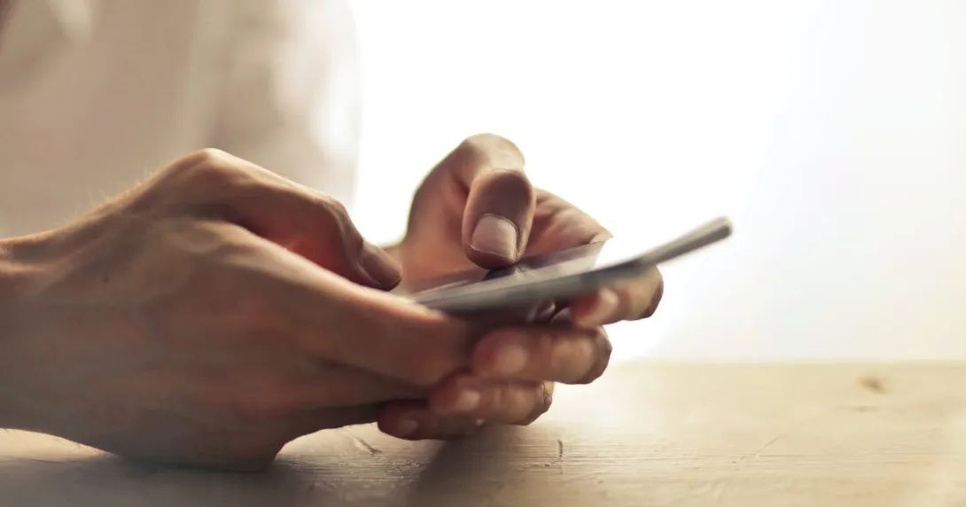 Hands texting on a phone