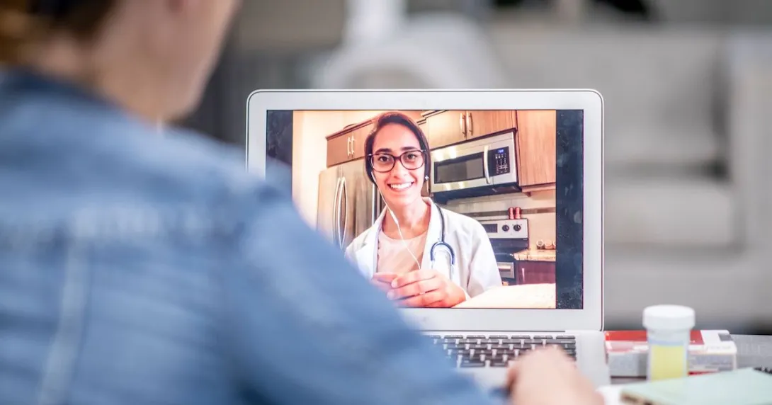 telehealth prescriber on laptop meets with a patient