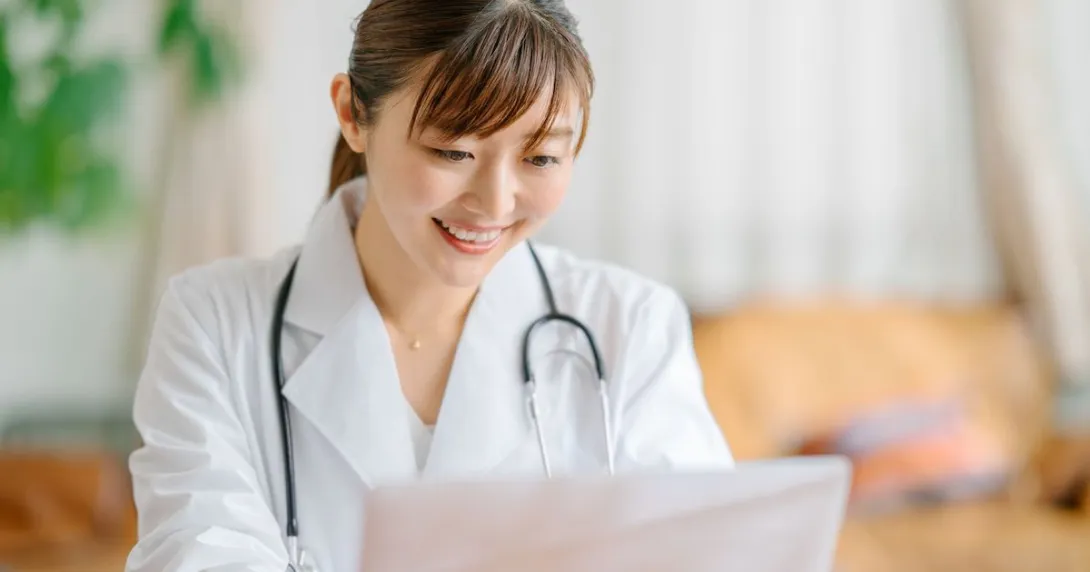 A doctor using a laptop computer