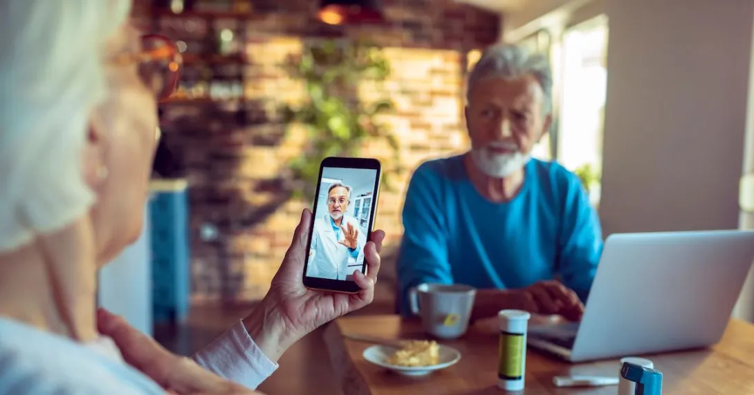 A senior couple consulting with their doctor on their mobile phone