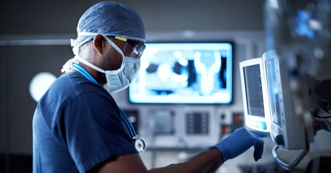 A surgeon looking at a monitor in an operating room