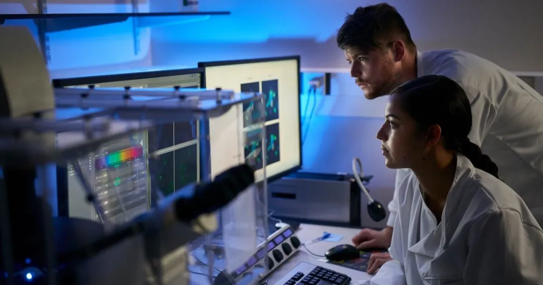 Scientists working on a desktop computer