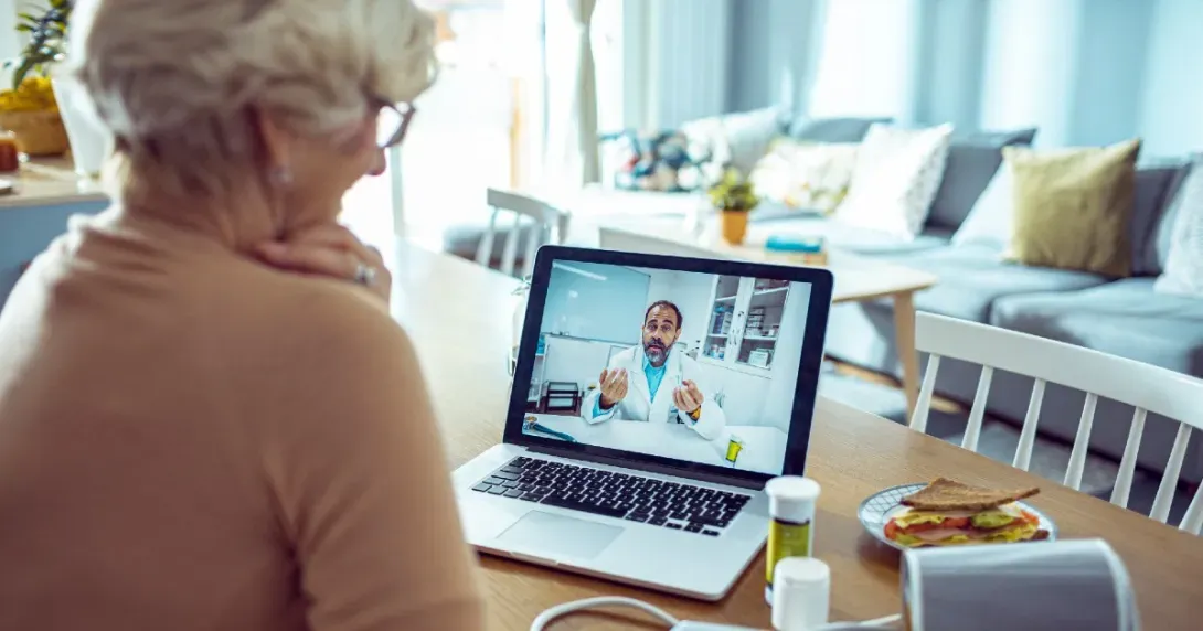 Senior patient speaks to her doctor on a telehealth call from home 