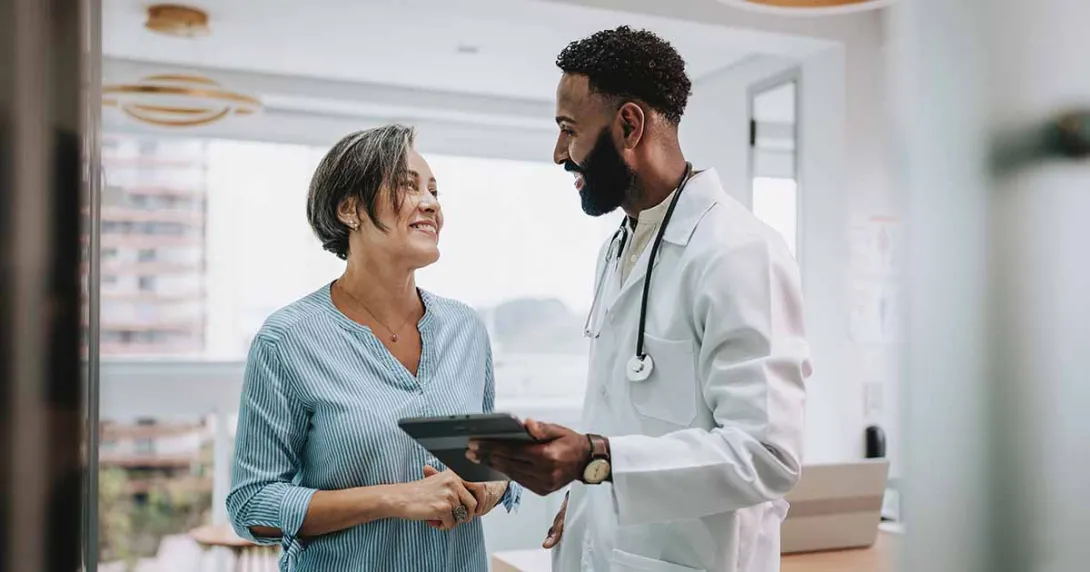 Doctor with tablet talking to patient