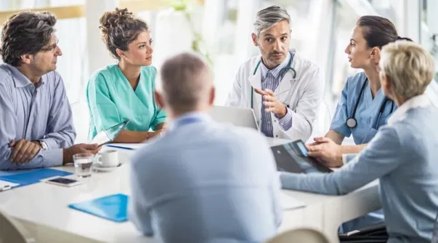 Healthcare leaders meeting to discuss clinical AI implementation