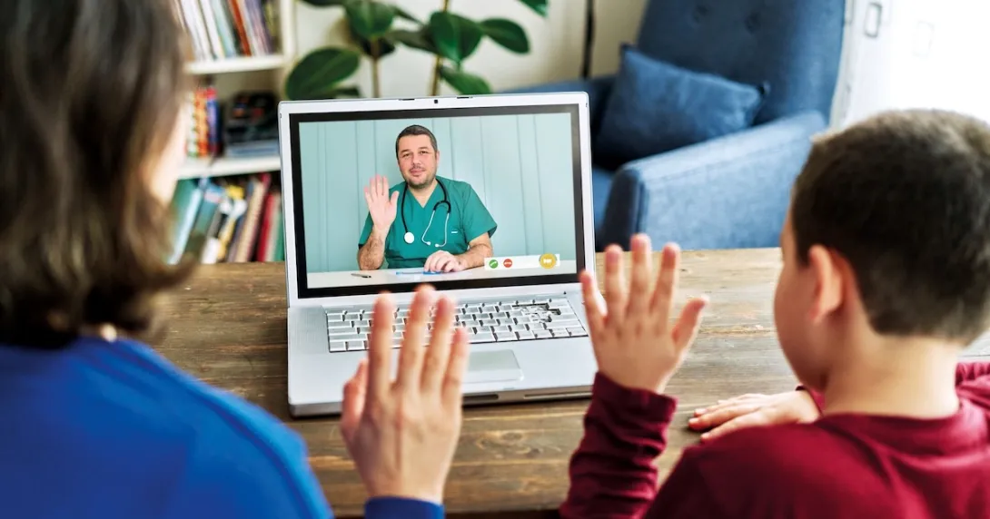 A parent and their child in a virtual consultation with a doctor