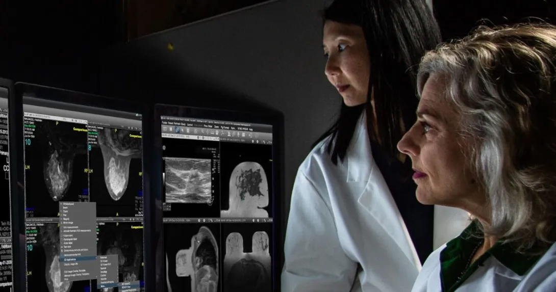 Two doctors in front of computer screens 