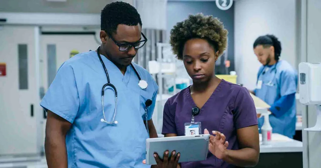 Healthcare workers in hospital looking at a tablet