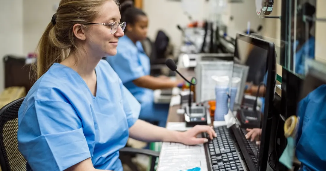Two nurses working the reception in a clinic