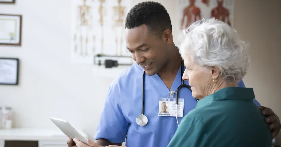 Doctor and veteran look at information on a tablet