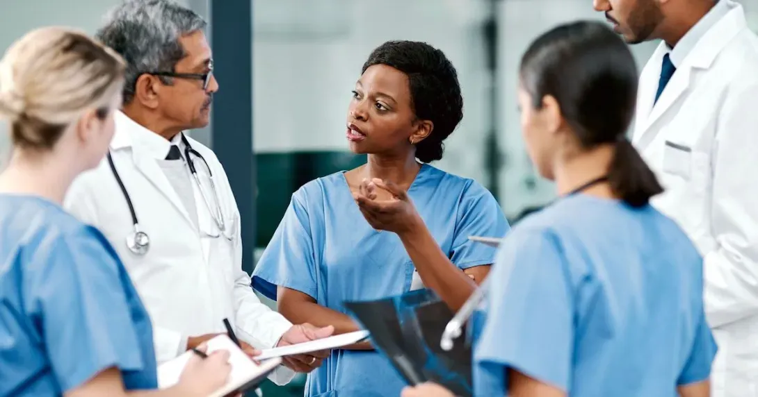 Clinicians huddle to discuss care plan