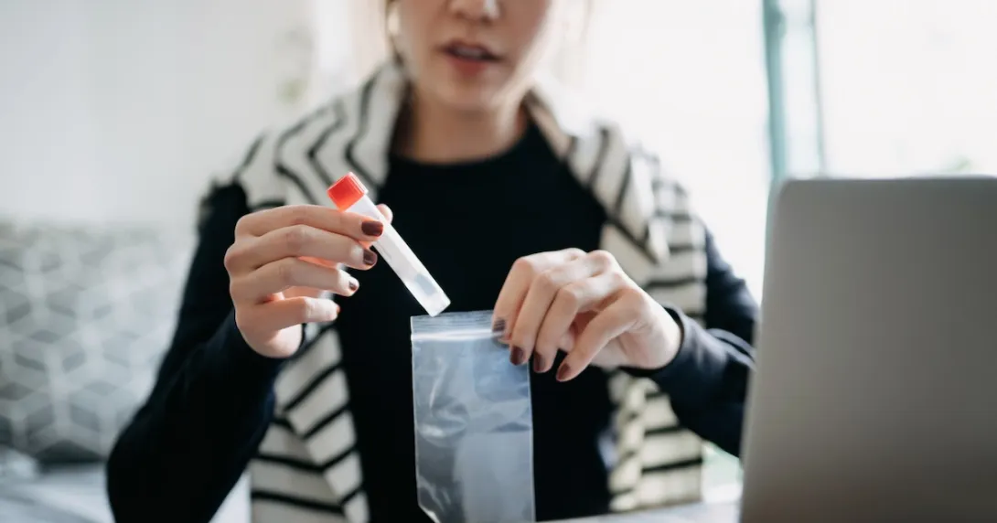  A patient inserting a test tube into a pouch 