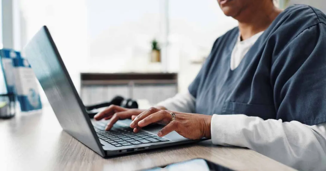 Healthcare worker using a laptop