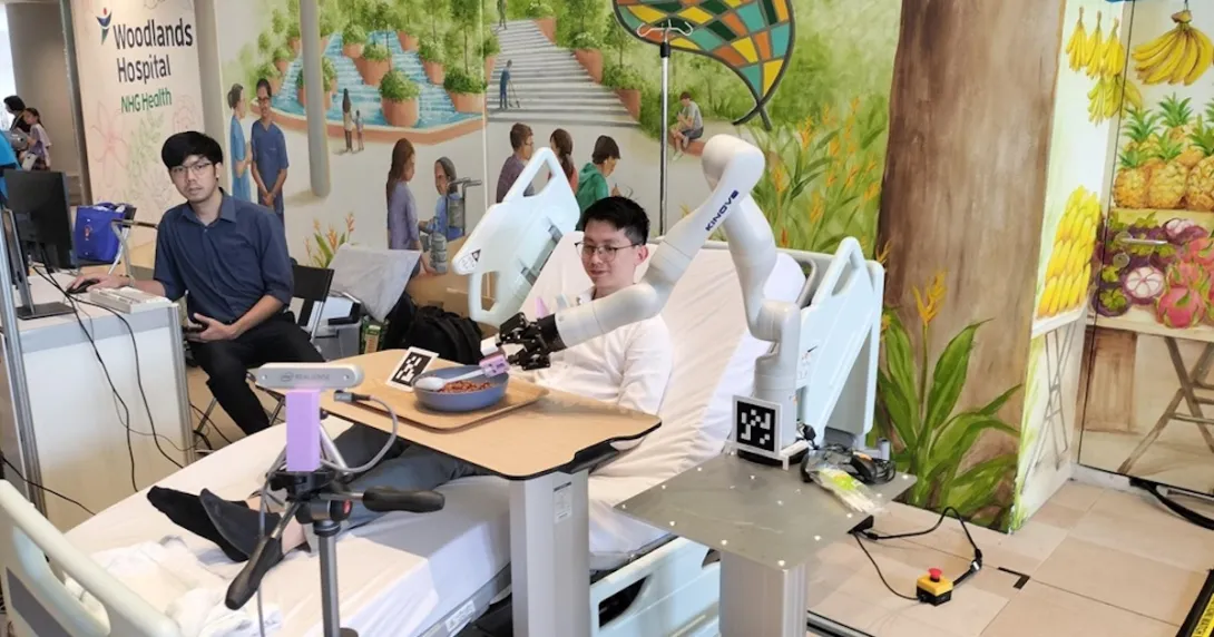 An assistive robot helping a patient with limited hand mobility to feed themselves