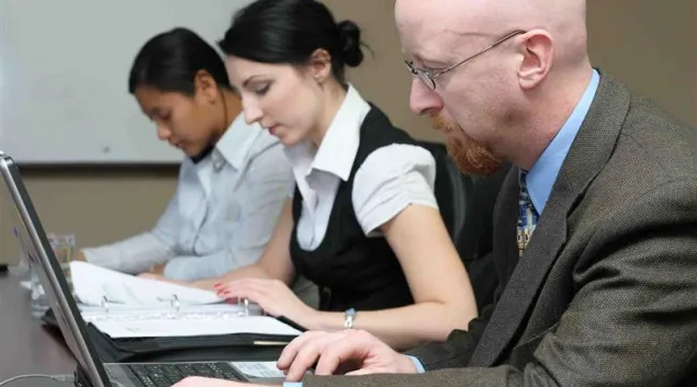Group of workers with laptops