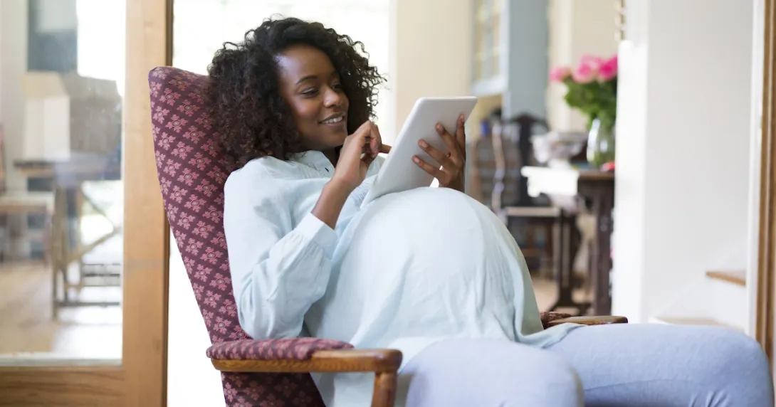 Pregnant person using tablet