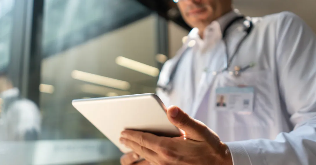Physician using tablet with AI clinical decision support