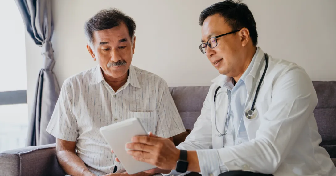 A doctor discussing a patient's health findings using a digital tablet.