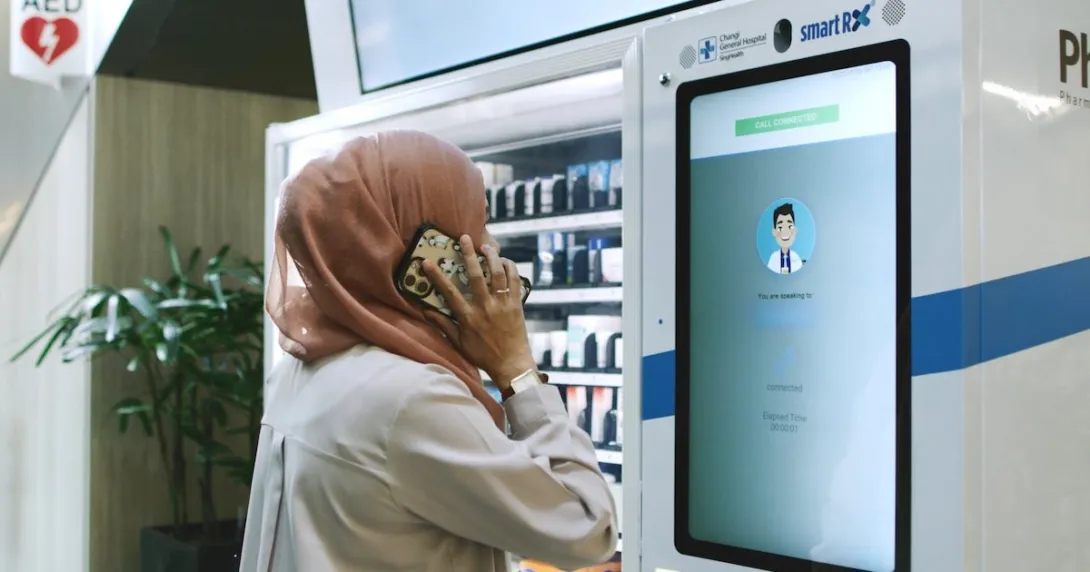 A patient in a teleconsultation with a pharmacist via PharmaSis vending machine