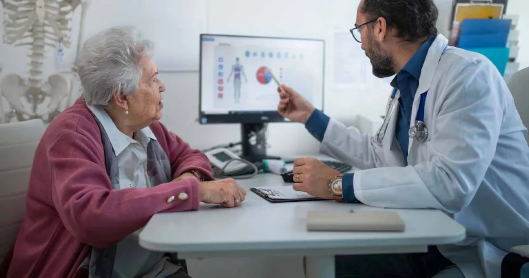 Doctor showing medical data on a screen to a patient